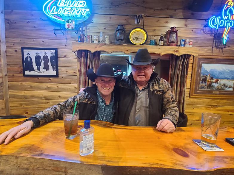 Shark and Jim sitting with each other at a table